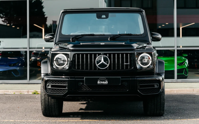 A picture of a 2023 Mercedes-Benz G63 in black color driving on a mountain road