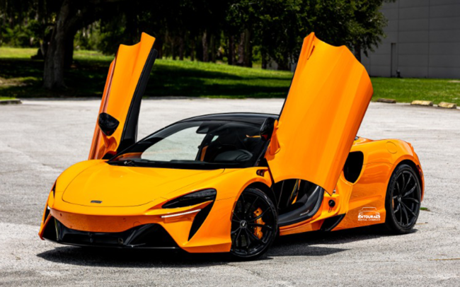 Picture of the new McLaren Artura 2024 hybrid car in orange color in Dubai from Entourage Car